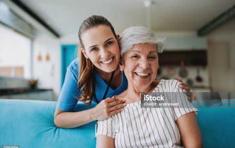 Home care healthcare professional hugging senior patient